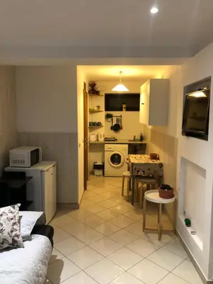 a living room with a kitchen and a table at Apartment near ocean Rua Alves Correia in Albufeira