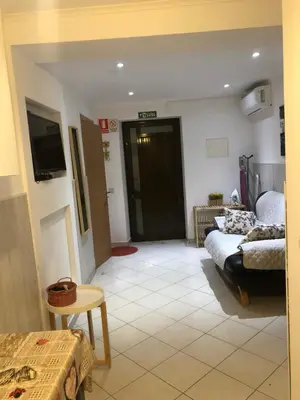 a living room with a couch and a tv at Apartment near ocean Rua Alves Correia in Albufeira