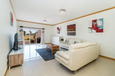 a living room with a couch and a television at Apartamento albufeira cerro da águia in Albufeira
