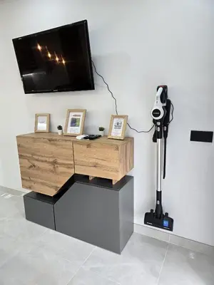 a desk with a tv and a camera on a wall at Comfy Home in Albufeira