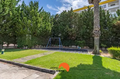a playground in a park with a tree and a swing at #201 Families Only - Quinta da Flor in Albufeira