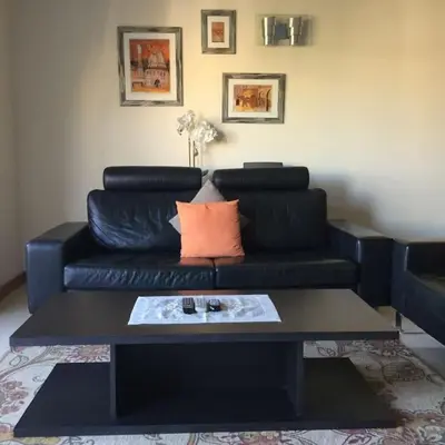 a black couch with a coffee table in a living room at Apartment Rosmaninho-Hosted by Sweetstay in Quarteira