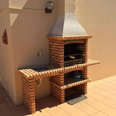 a brick oven in the corner of a room at Apartment Rosmaninho-Hosted by Sweetstay in Quarteira