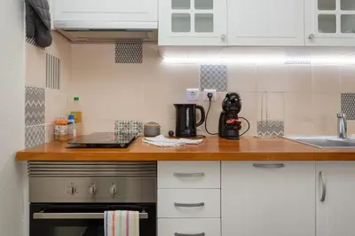 a kitchen counter with a coffee maker on it at Algarvian Experience - Sun, Beach and Pool in Albufeira