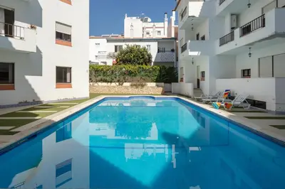a swimming pool in the middle of a building at Algarvian Experience - Sun, Beach and Pool in Albufeira