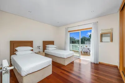 two beds in a room with a balcony at Meadow View Retreat in Albufeira