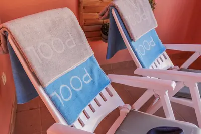 two beach chairs with a towel on them at Avenue Apartment Vilamoura in Quarteira