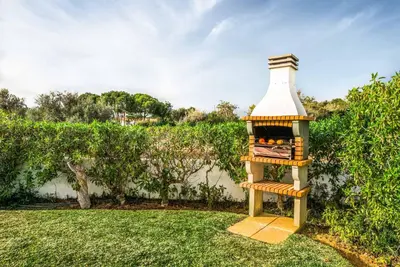 a wooden bird feeder sitting in the grass at Villa Barrancos in Guia