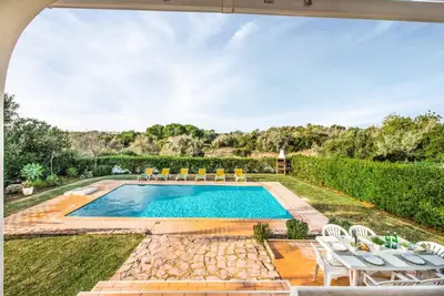 an outdoor swimming pool with chairs and a table at Villa Barrancos in Guia