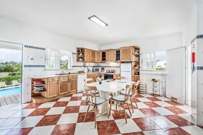 a kitchen with a table and chairs in it at Villa Barrancos in Guia