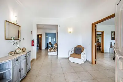 a living room with a couch and a chair at Villa Godinho in Albufeira