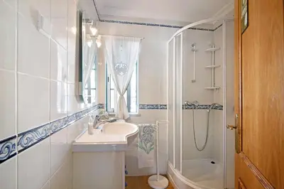 a white bathroom with a sink and a shower at Casa Estrela do Mar, 2 Quartos, Praia de São Rafael, Albufeira in Albufeira