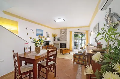 a living room with a table and a dining room at Casa Estrela do Mar, 2 Quartos, Praia de São Rafael, Albufeira in Albufeira