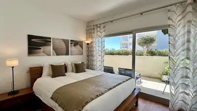 a bedroom with a large bed and a large window at Harmony by Check-in Portugal in Albufeira