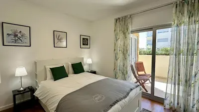 a bedroom with a bed and a window with a balcony at Harmony by Check-in Portugal in Albufeira