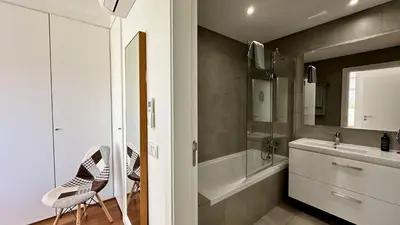 a bathroom with a sink and a bath tub at Harmony by Check-in Portugal in Albufeira