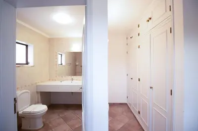 a bathroom with a toilet and a sink at Villa Angélica - Cozy Homestay in Albufeira