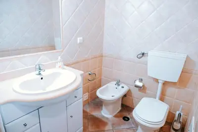 a bathroom with a sink and a toilet at Villa Angélica - Cozy Homestay in Albufeira