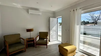a living room with two chairs and a window at Hibisco 1 by Check-in Portugal in Albufeira