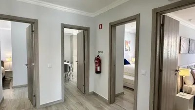 a hallway with two doors leading to a bedroom at Hibisco 1 by Check-in Portugal in Albufeira