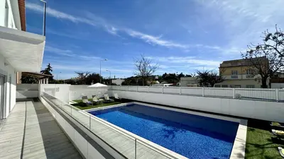 a swimming pool on the side of a house at Hibisco 1 by Check-in Portugal in Albufeira