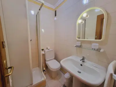 a bathroom with a sink and a toilet and a mirror at Varandas do Sol by Garvetur in Vilamoura