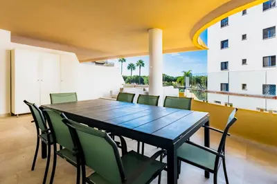 a dining room with a table and chairs on a balcony at Varandas do Sol by Garvetur in Vilamoura