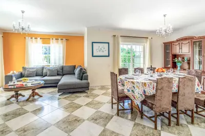 a living room with a table and a couch at Villa Judite in Albufeira
