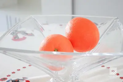 three oranges in a glass bowl on a table at Apartamentos Sereia da Oura in Albufeira