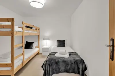 a bedroom with two bunk beds and a lamp at Extraordinary Villa on an elevated position in Quinta do Lago in Quinta do Lago