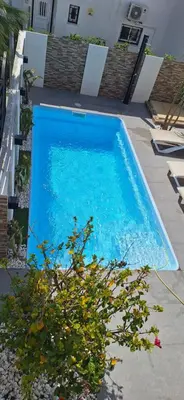 a large blue swimming pool in a yard at Casinha do sul- Private pool in Albufeira
