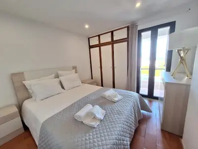 a bedroom with a bed with towels on it at Casinha do sul- Private pool in Albufeira