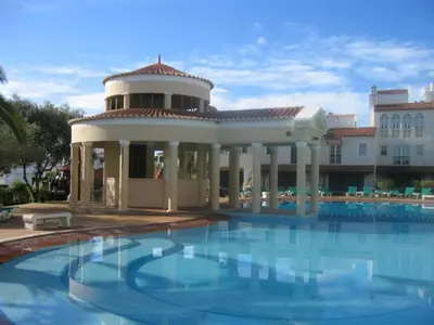 a large swimming pool in front of a building at Old Village Vilamoura in Quarteira