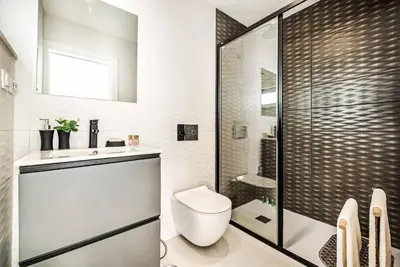 a bathroom with a shower and a toilet and a sink at Villa Aventura in Albufeira