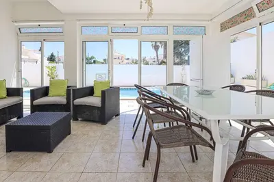 a dining room with a table and chairs at Villa Vivienda Rosa in Albufeira