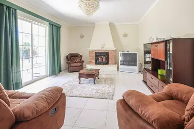 a living room with two couches and a fireplace at Villa Vivienda Rosa in Albufeira
