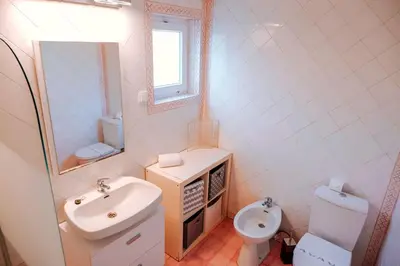 a bathroom with a sink and a toilet and a mirror at Villa Coelha - Algarve's Pearl in Albufeira