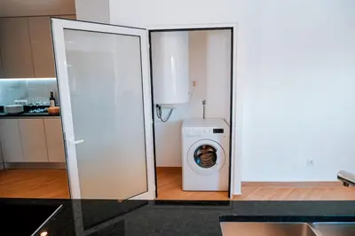 a washer and dryer in a white kitchen at Villa Coelha - Algarve's Pearl in Albufeira
