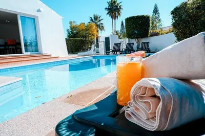 a drink on a tray next to a swimming pool at Villa Coelha - Algarve's Pearl in Albufeira