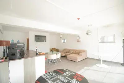 a kitchen and living room with a couch and a table at Villa dos Sonhos - Wide Dreams in Albufeira