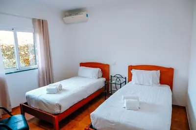 a bedroom with two beds and a window at Villa dos Sonhos - Wide Dreams in Albufeira
