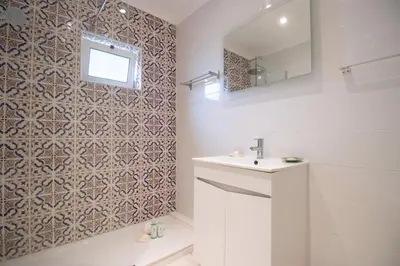 a bathroom with a sink and a mirror at Villa dos Sonhos - Wide Dreams in Albufeira