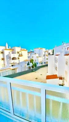 a view of a balcony with white buildings at Apartamento 5 Estrelas Praia da Oura in Albufeira