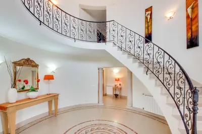 a spiral staircase in a home with a mirror at Villa Lisianto in Albufeira