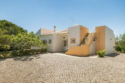 a house with a brick driveway in front of it at Villa Cerrinho in Albufeira