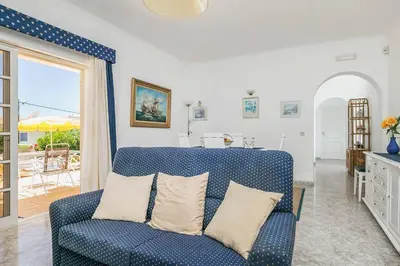 a blue couch in a living room with a patio at Villa Cerrinho in Albufeira