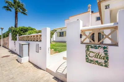 a white house with a sign on the side of it at Villa Tilia in Galé