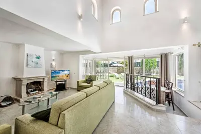 a living room with a couch and a fireplace at Villa Tilia in Galé