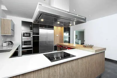 a kitchen with black and white appliances and a counter at Villa Dala in Albufeira