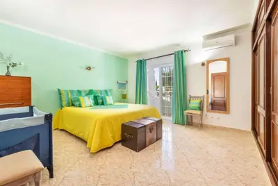 a bedroom with a bed and a tv in it at Casa Oliveira in Albufeira